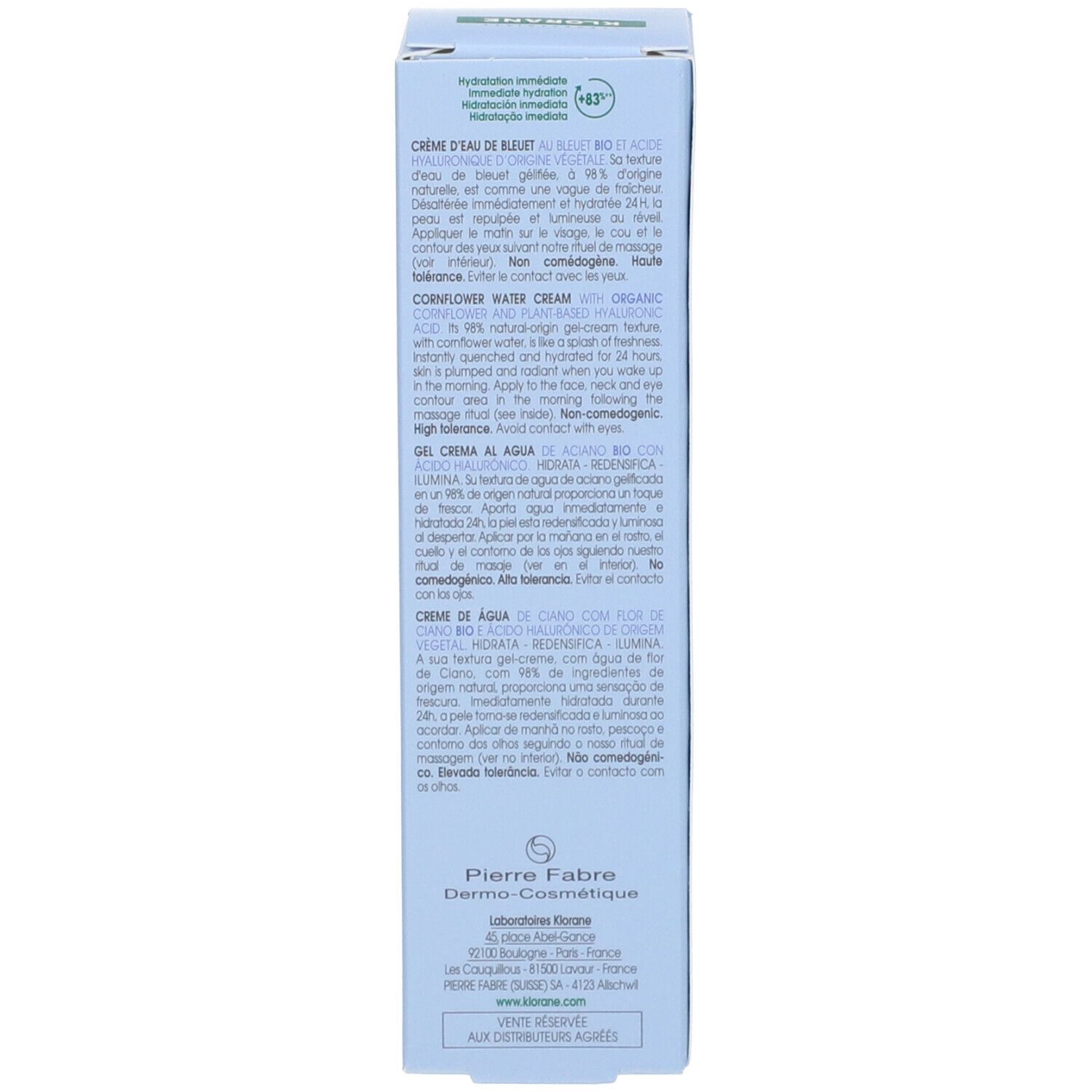 Dos de la boîte bleu clair. Texte en plusieurs langues. Contient des informations sur la Crème d'Eau de Bleuet.