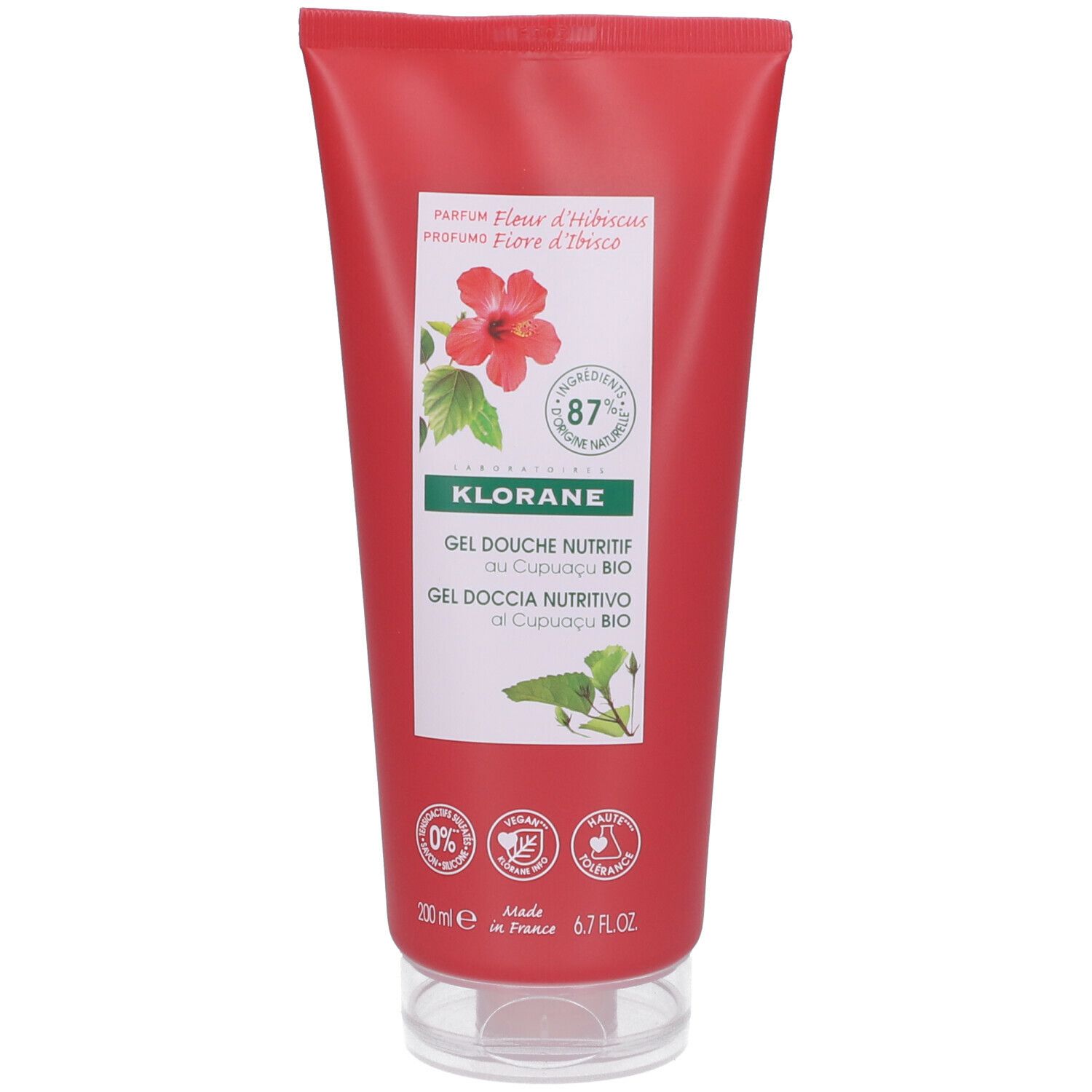 Tube rouge de gel douche Klorane Fleur d'Hibiscus. Impression d'une fleur d'hibiscus et de feuilles vertes. 87% d'ingrédients d'origine naturelle.