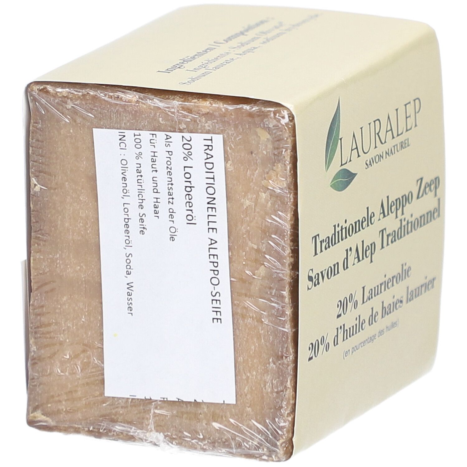 Blockseife in Verpackung. Aufschrift: Traditionelle Aleppo Seife, 20% Lorbeeröl. Inhaltsstoffe.