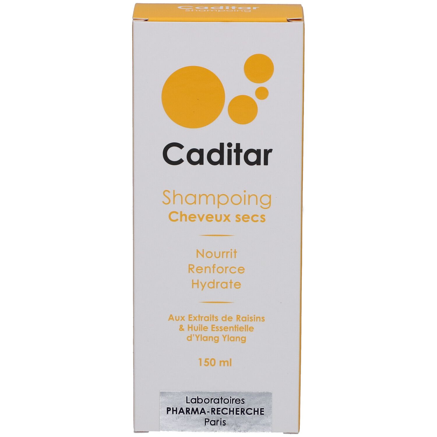 Emballage carton avec accent jaune. Inscription: Caditar, Shampoing Cheveux secs, Nourrit, Renforce, Hydrate.