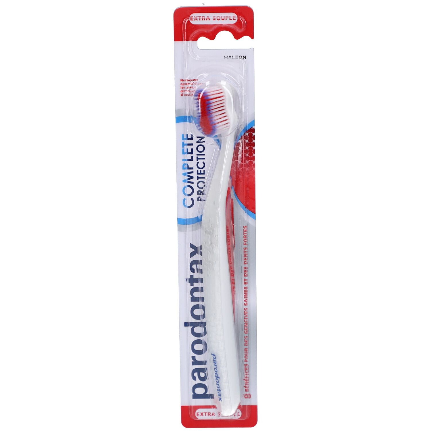 Brosse à dents dans son emballage. Manche blanc, tête rouge et blanche. Marque parodontax. "COMPLETE PROTECTION" et "EXTRA SOUPLE" visibles.
