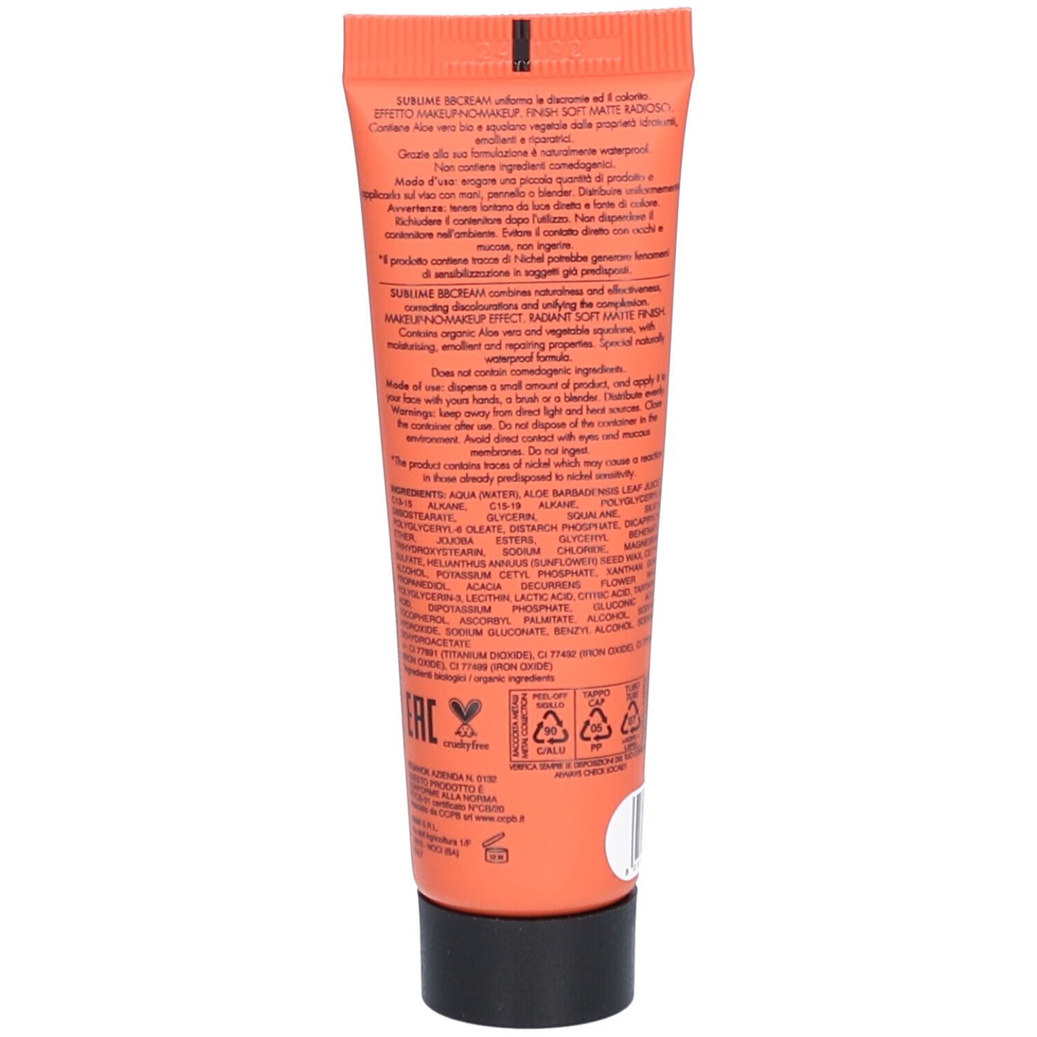 Dos d'un tube orange. Texte avec informations sur le produit, ingrédients et certifications. Bouchon noir.