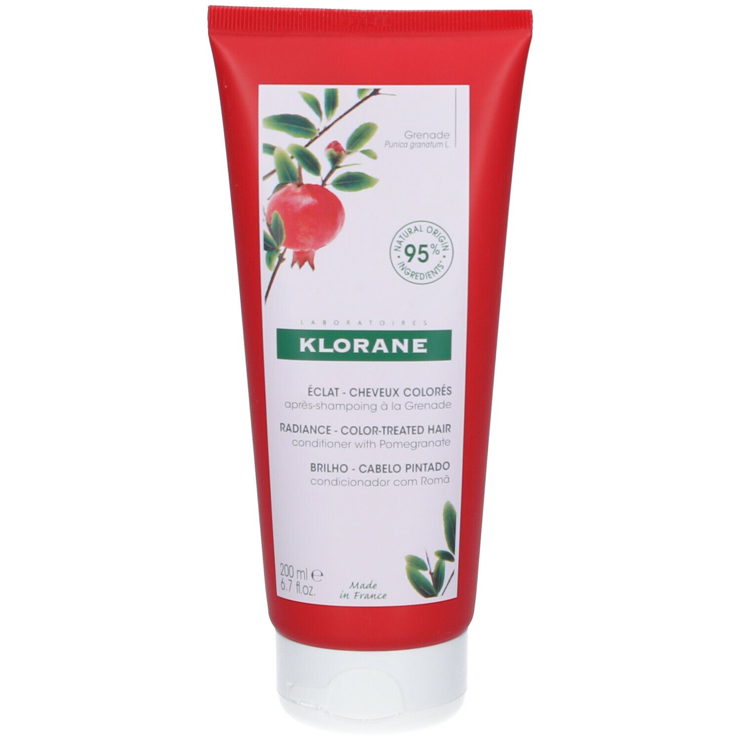 Tube rouge KLORANE. Inscription: Éclat cheveux colorés, conditionneur au grenade. 95% ingrédients d'origine naturelle.