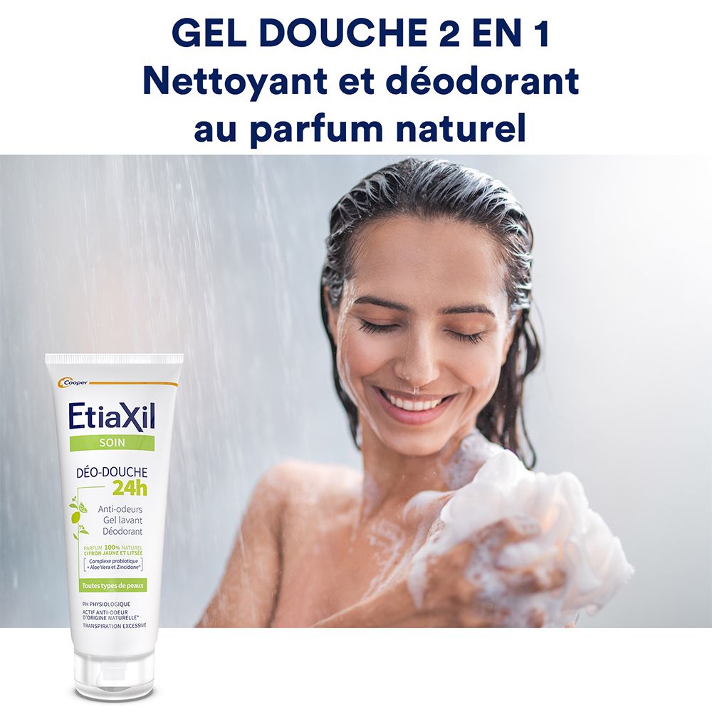 Frau duscht. Etiaxil Déo-Douche 24H. Tube sichtbar. Text: Gel Douche 2 en 1.
