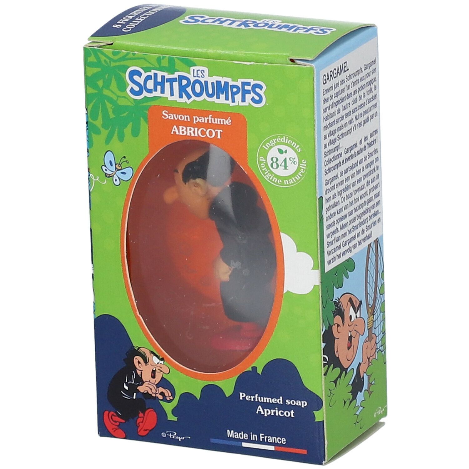 Savon parfumé Abricot avec figurine Gargamel dans boîte. Boîte verte avec texte et illustrations. Produit visible à travers fenêtre.