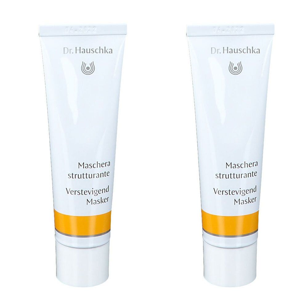 Deux tubes blancs avec une bande jaune. Inscription : Dr. Hauschka, Maschera strutturante, Verstevigend Masker.