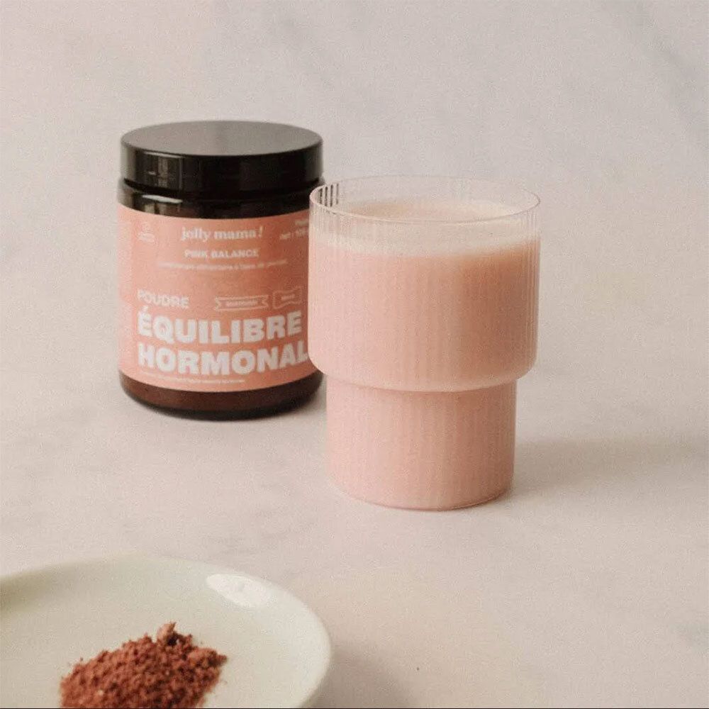 Dose JOLLY MAMA Pink Balance und Glas rosa Flüssigkeit. Auf einem Teller: rosa Pulver. Text: ÉQUILIBRE HORMONAL.