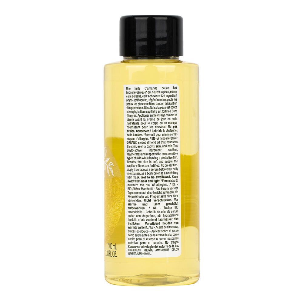 Rückseite der LAINO Huile d’amande douce bio Flasche. Text in mehreren Sprachen, gelbes Öl sichtbar.