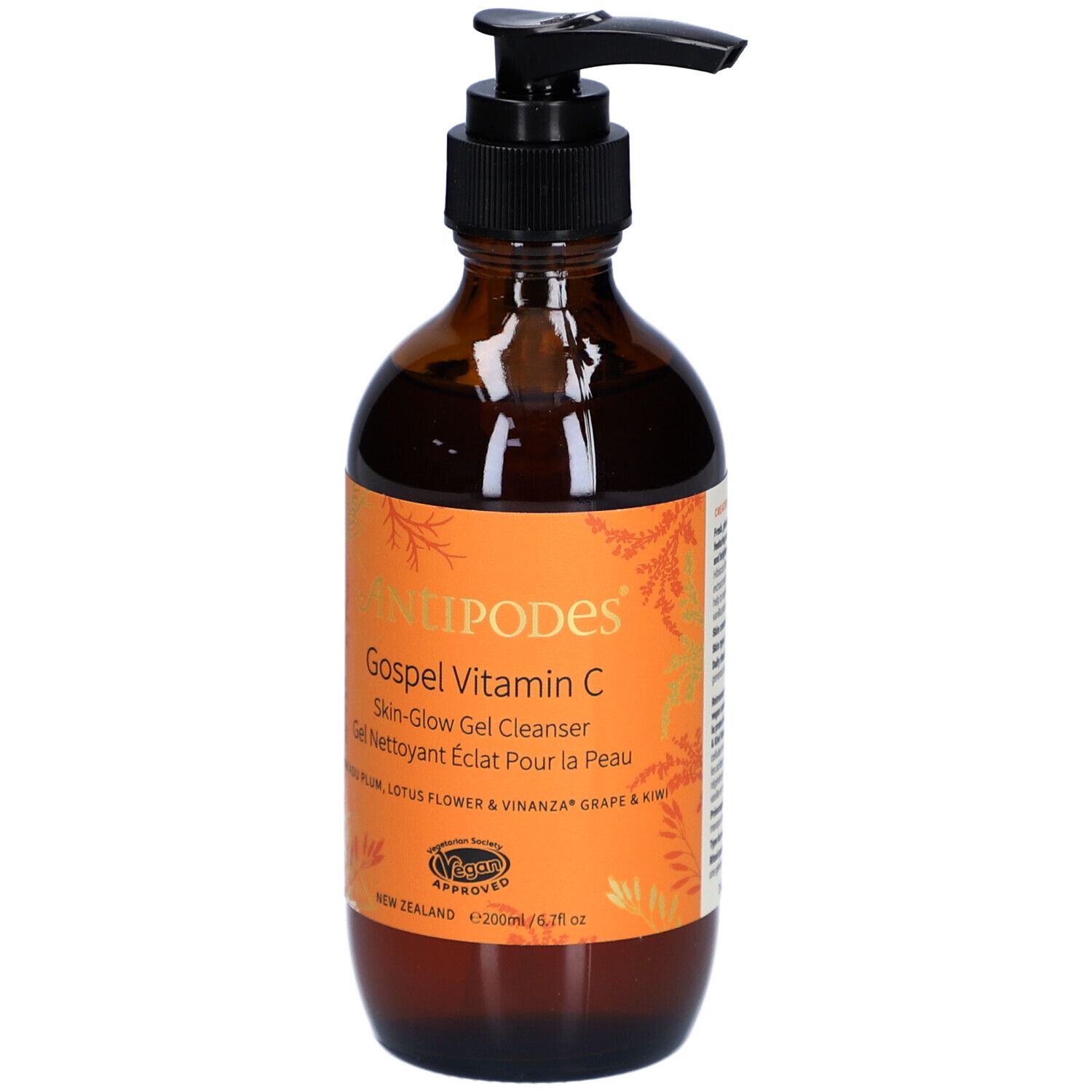 Flacon en verre brun avec pompe noire. Étiquette orange avec nom du produit et texte. Certification végétalienne.