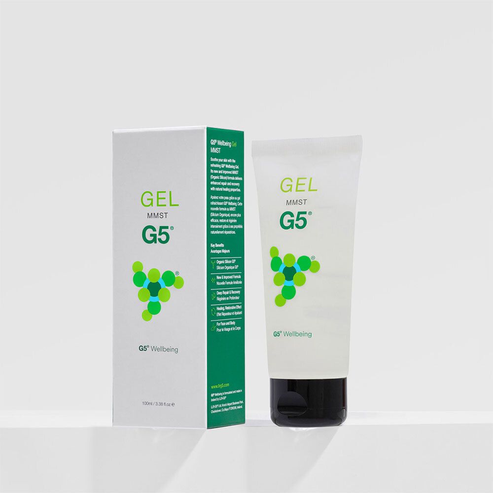 Weiße Tube und Verpackung. Aufschrift: GEL MMST G5. Logo: grüne Kreise. Schwarzer Verschluss.