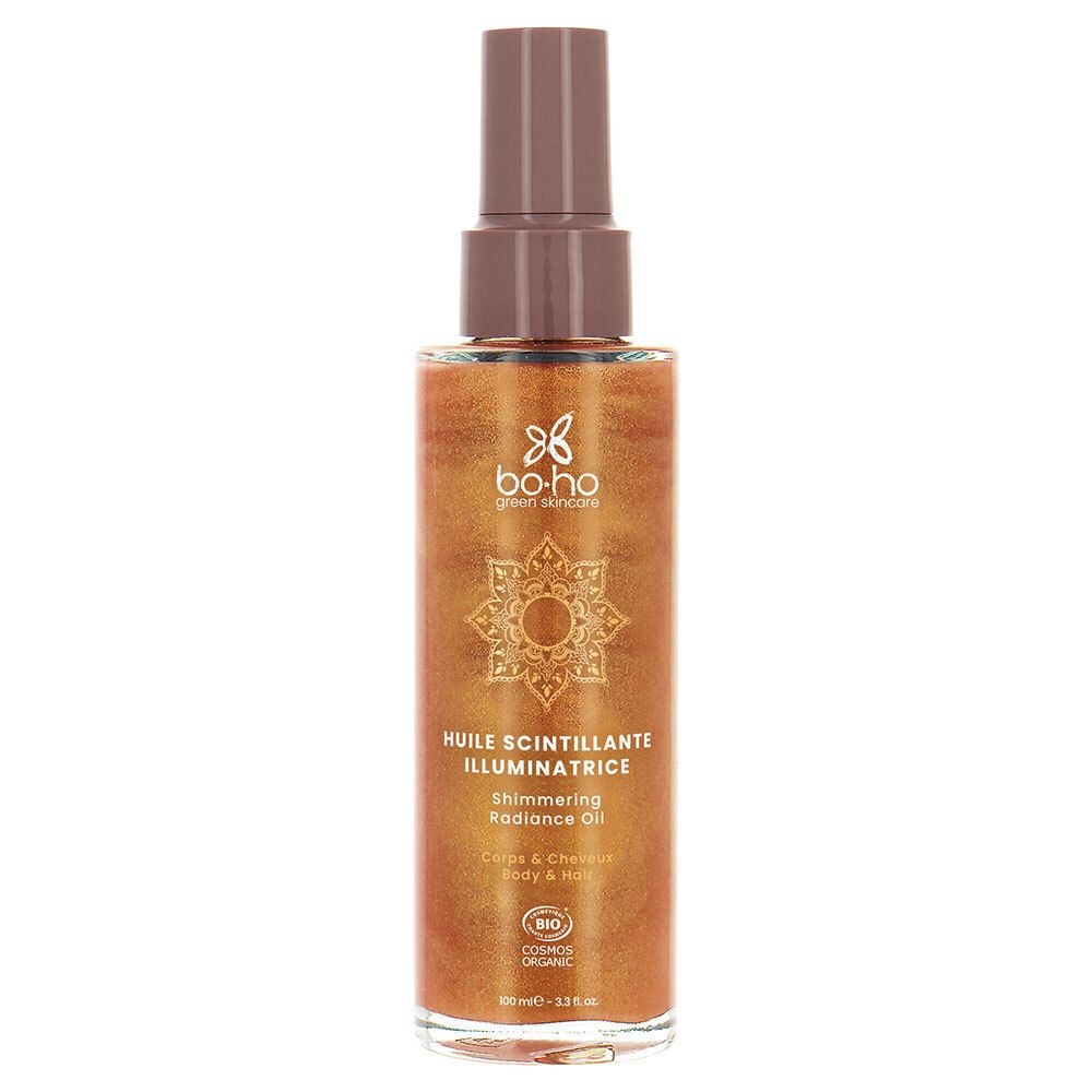 Braunes Schimmeröl in einer Sprühflasche. Aufschrift: Huile Scintillante Illuminatrice, Shimmering Radiance Oil. Bio-Zertifizierung.