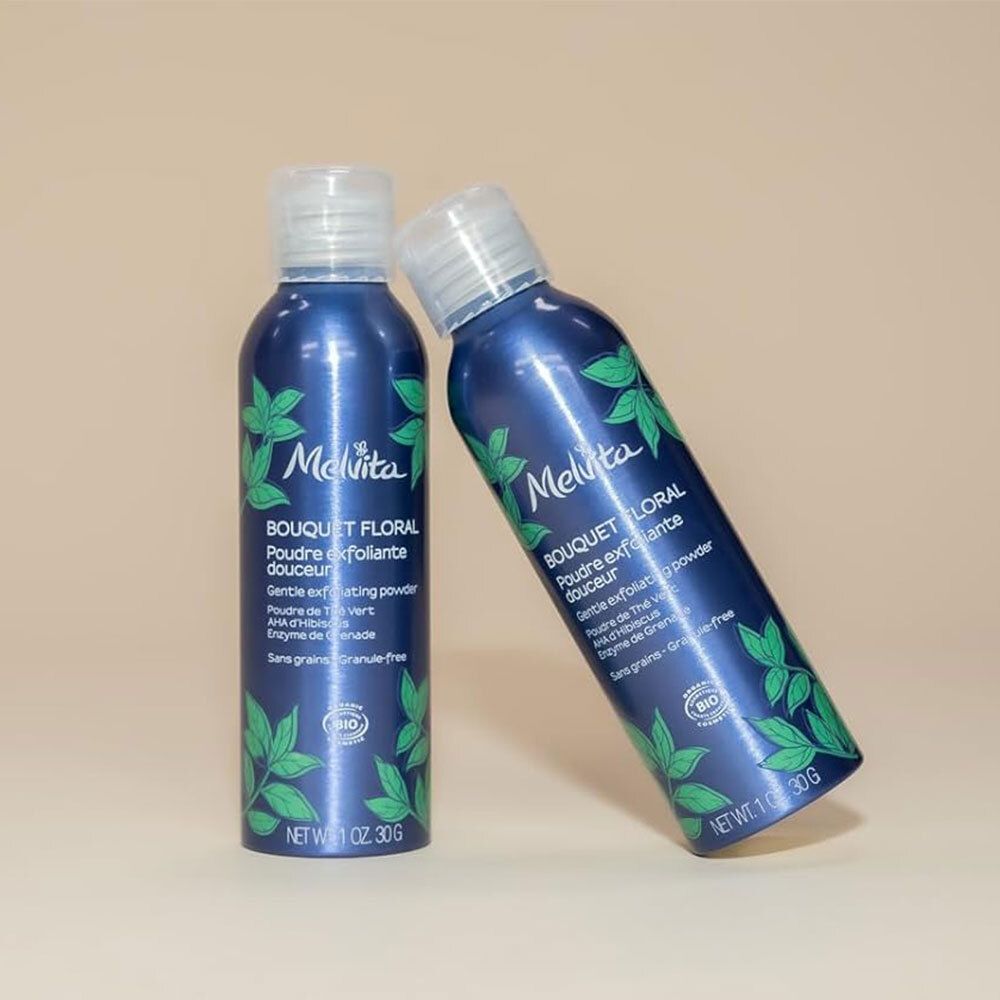 Zwei blaue Flaschen mit weißem Deckel. Aufschrift: Melvita, Bouquet Floral, Poudre exfoliante douceur. Bio-Zertifizierung.