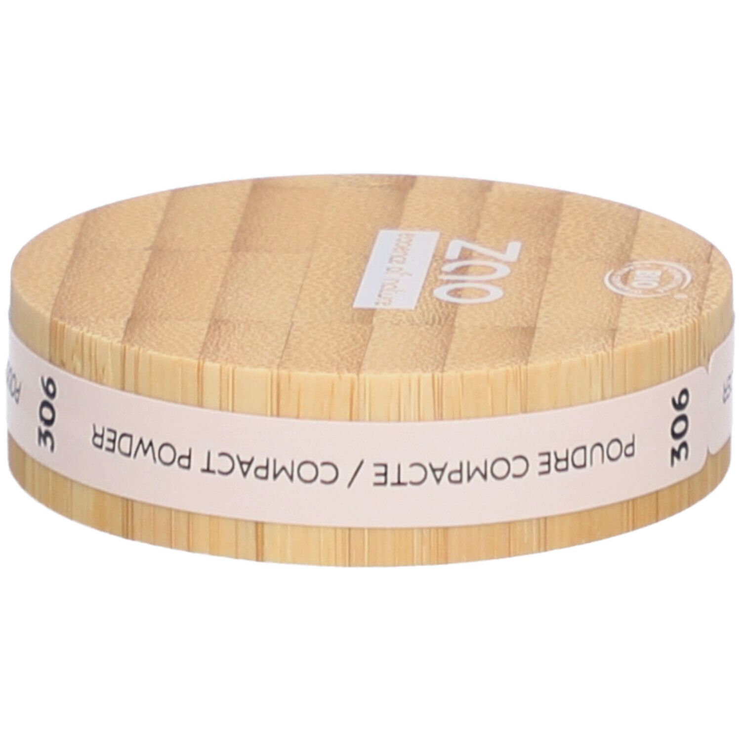 Boîtier rond de poudre compacte en bois. Inscriptions : ZAO, essence of nature, 306, Poudre Compacte / Compact Powder.