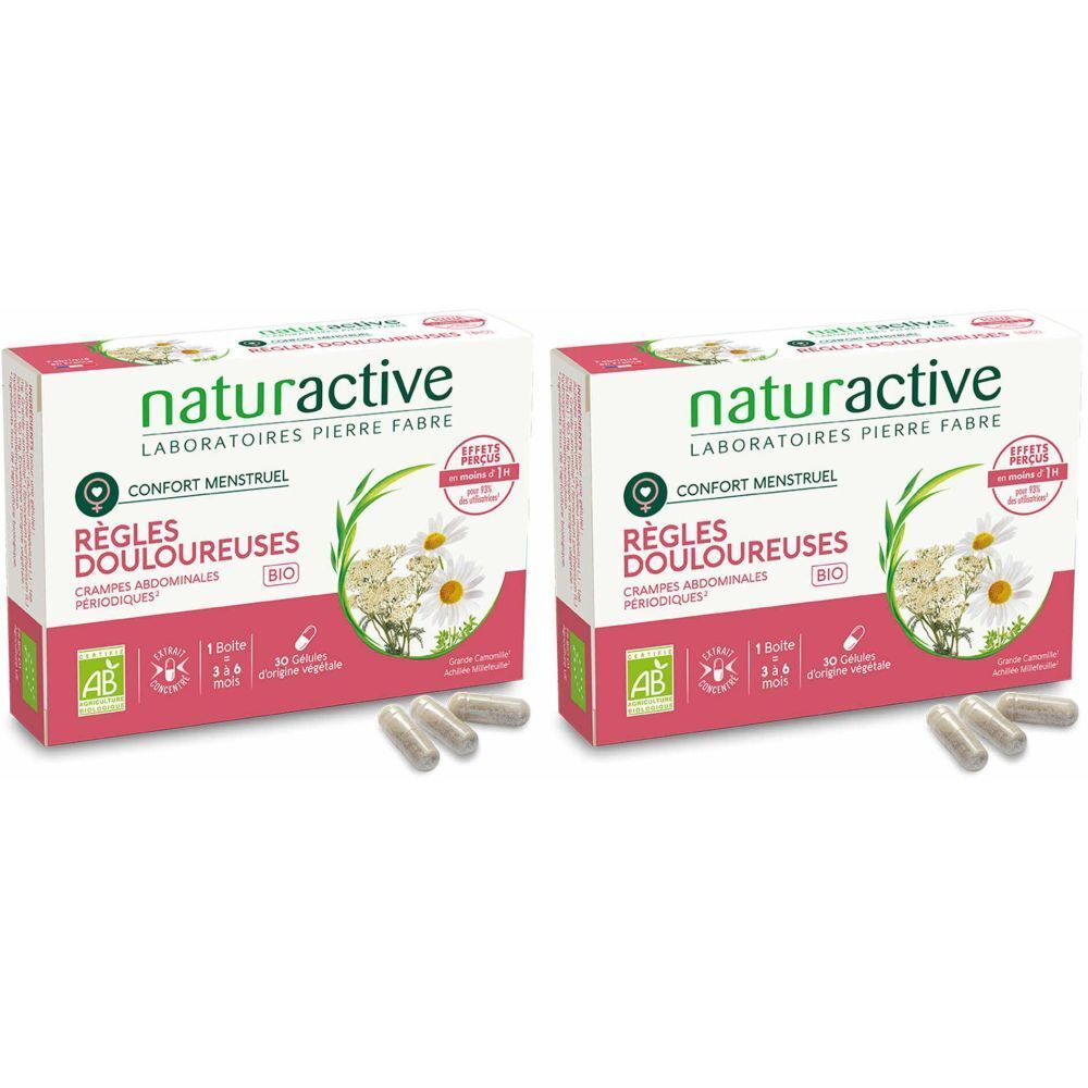 Zwei Schachteln mit Kapseln. Aufdruck: naturactive, RÈGLES DOULOUREUSES, BIO. Einige Kapseln liegen vor den Schachteln.