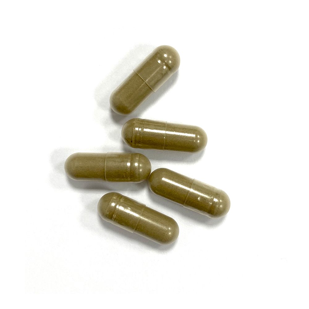 Cinq gélules marron sur fond blanc. Forme de gélule.