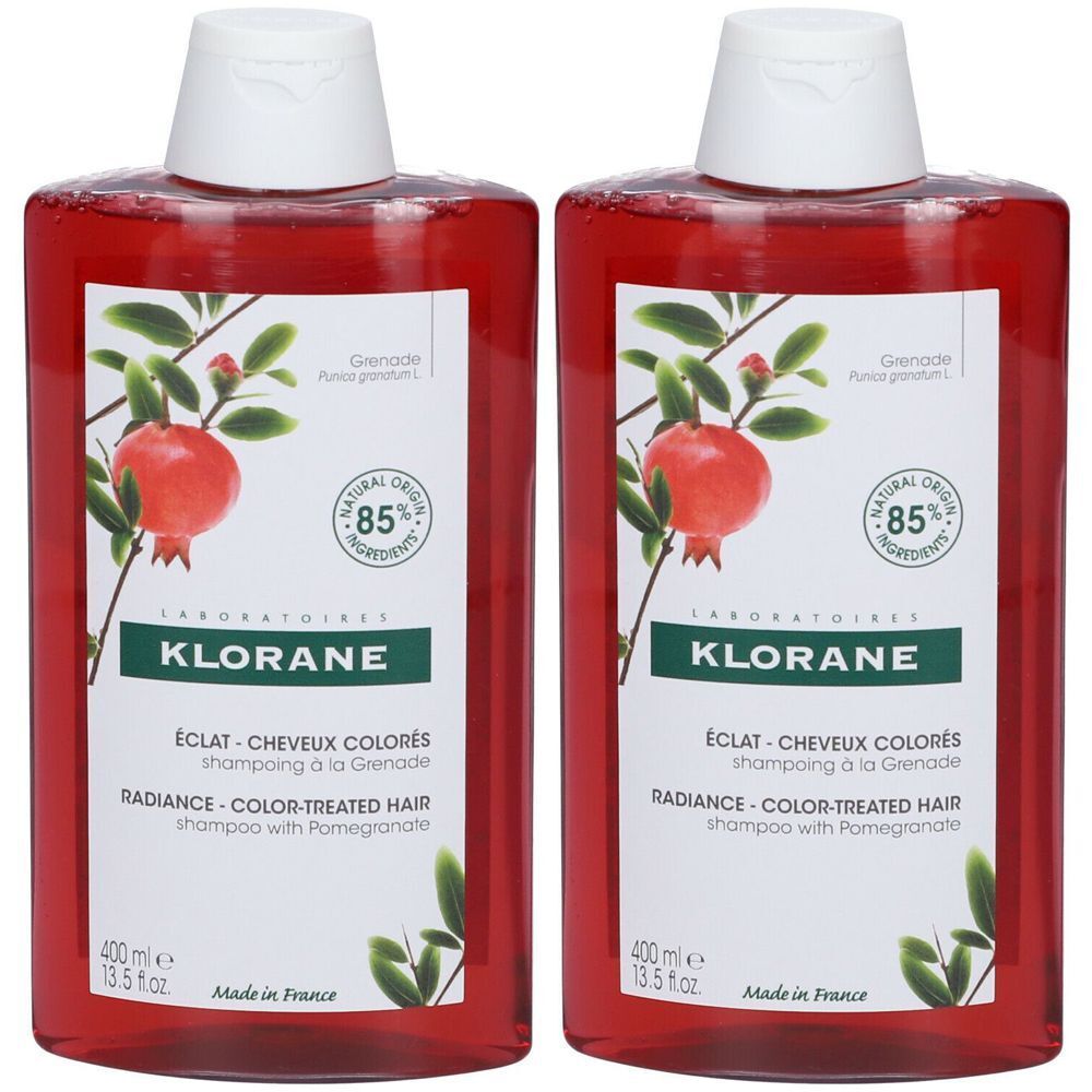 Zwei rote Flaschen Shampoo. Auf dem Etikett: Klorane, Granatapfel-Abbildung, 85% natürliche Inhaltsstoffe. Text: Éclat-Cheveux Colorés.
