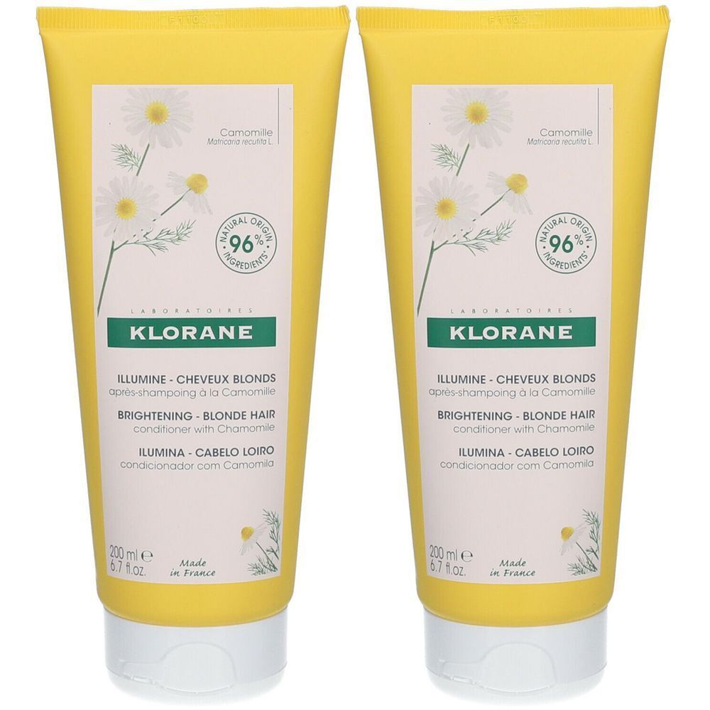 Deux tubes jaunes avec étiquette blanche. Inscription: KLORANE, ILLUMINE CHEVEUX BLONDS, BRIGHTENING BLONDE HAIR. Motif camomille et 96% ingrédients naturels.