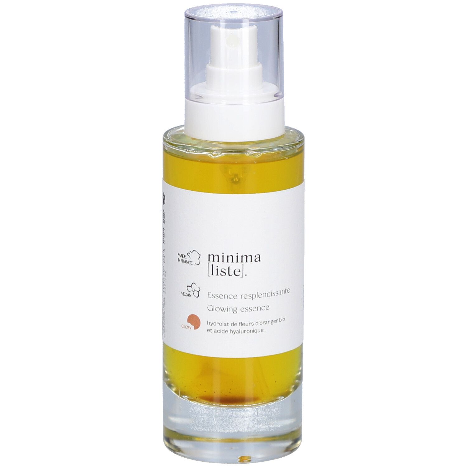 Flacon en verre avec liquide jaune et vaporisateur. Inscription : minima liste. Essence resplendissante, Glowing essence.