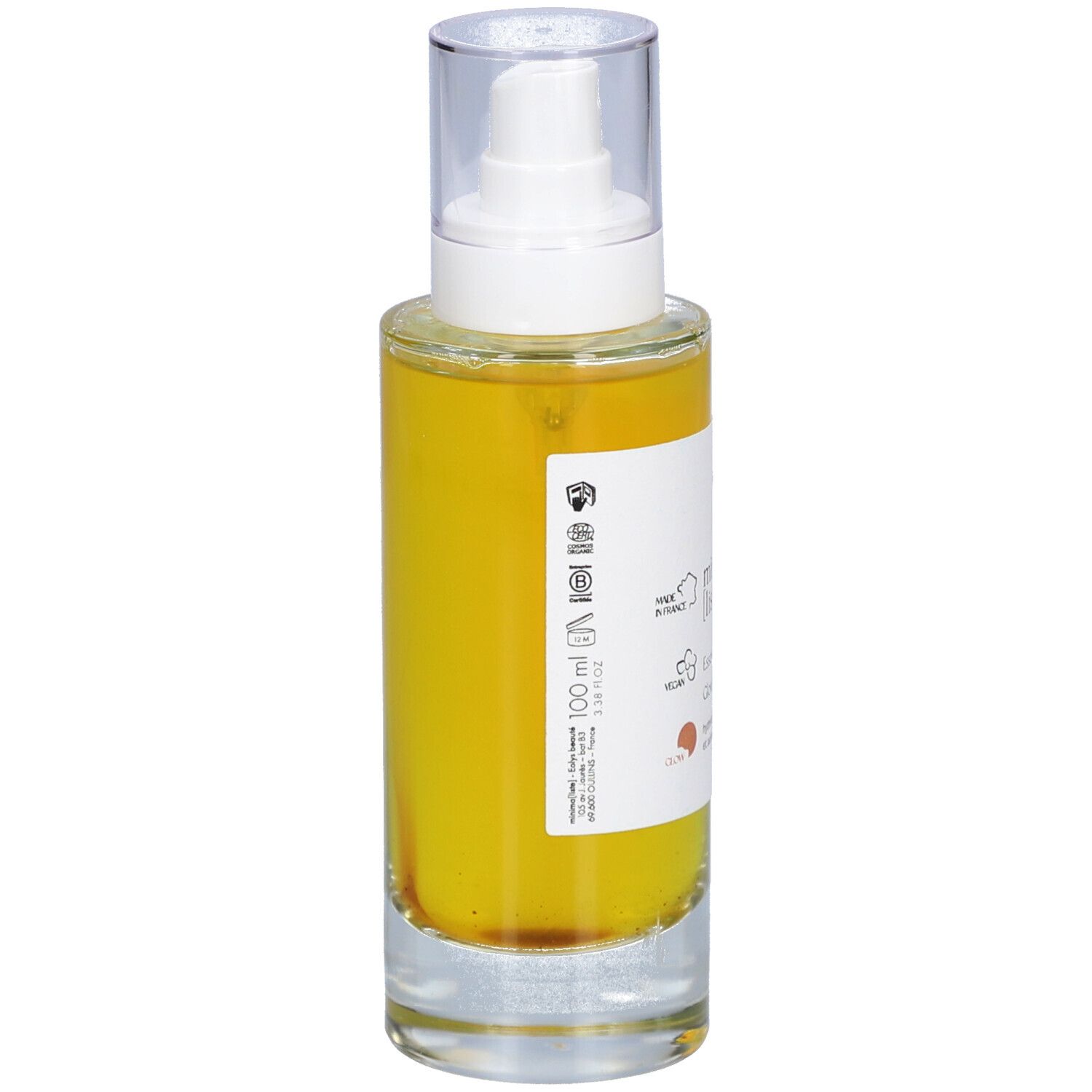 Flacon en verre avec liquide jaune et vaporisateur. Inscription : minima liste. Essence resplendissante, Glowing essence. 100 ml.