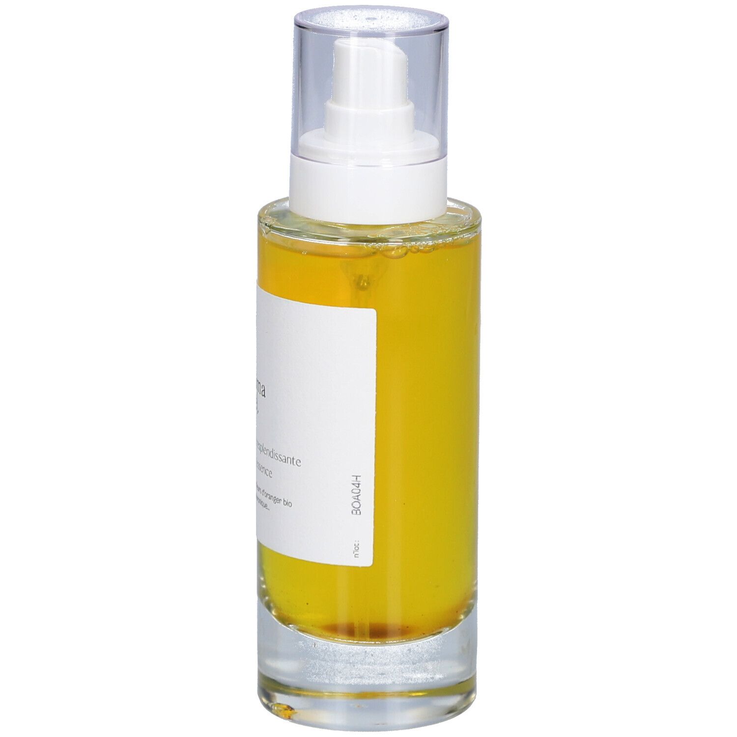 Flacon en verre avec liquide jaune et vaporisateur. Inscription : minima liste. Essence resplendissante, Glowing essence.