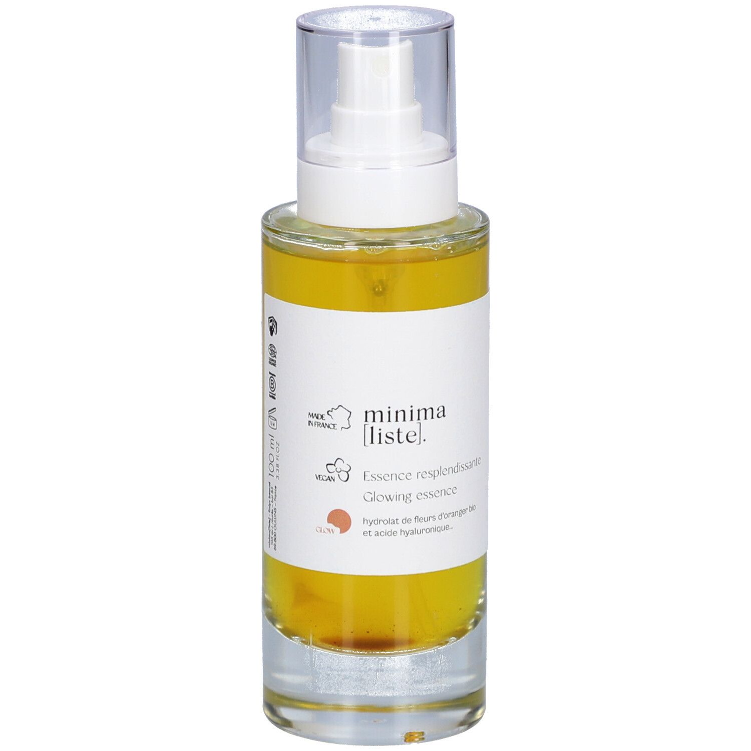 Flacon en verre avec liquide jaune et vaporisateur. Inscription : minima liste. Essence resplendissante, Glowing essence.