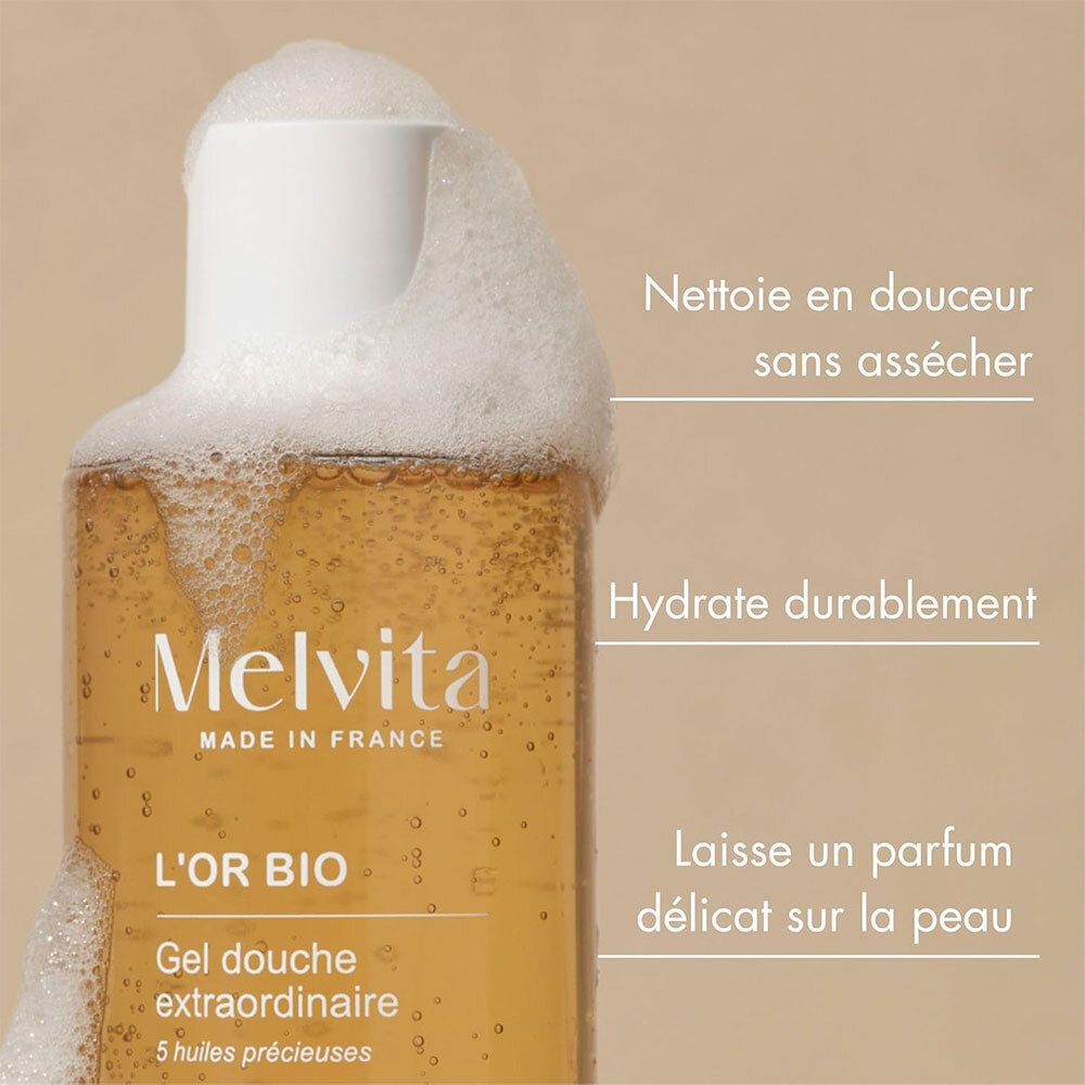 Melvita L'Or Bio Gel Douche Extraordinaire. Flasche mit Schaum. Text: Reinigung, Feuchtigkeit, Duft.