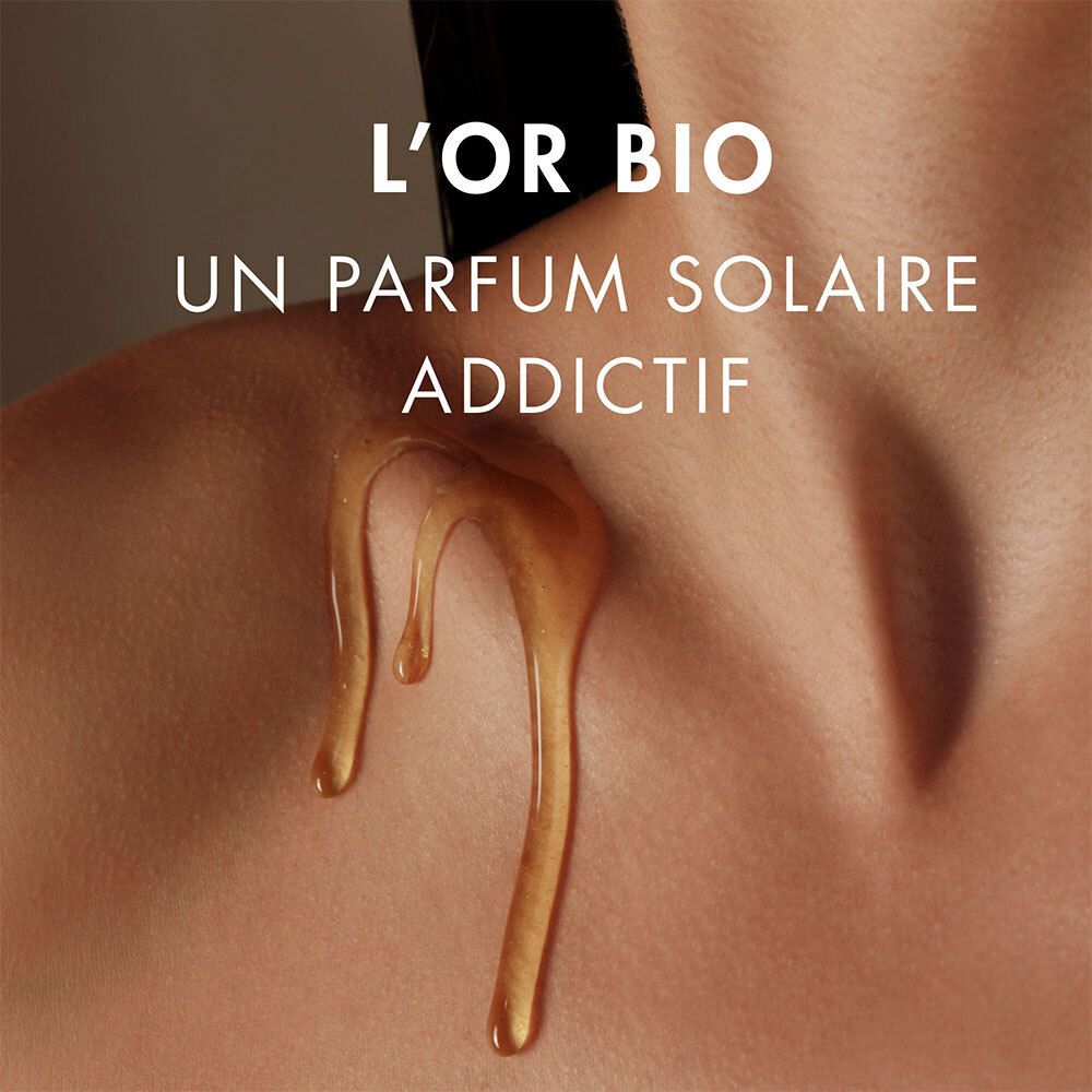 Goldfarbenes Öl fließt über die Haut. Text: L'OR BIO, ein süchtig machender sonniger Duft.