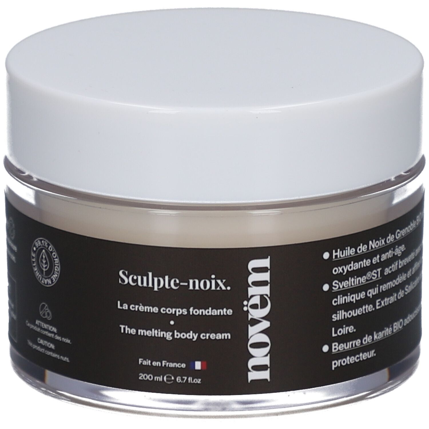 Cremetiegel mit weißem Deckel. Schwarzes Etikett mit Text: Sculpt-noix, La crème corps fondante, novëm. 200 ml. Durchsichtiges Glas.