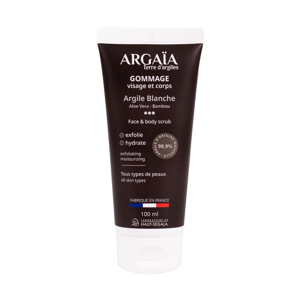 Tube de gommage pour le visage et le corps. Tube noir avec bouchon blanc. Texte: Argaia, Gommage Visage et Corps, Argile Blanche, 100 ml.