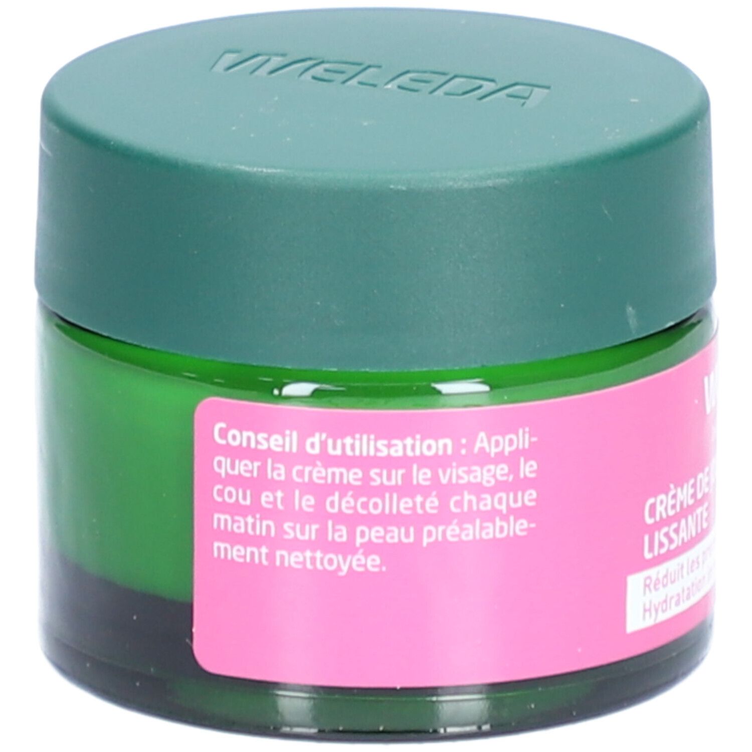 Grünes Glas mit grünem Deckel. Rosa Etikett mit Anwendungshinweisen. Text: Conseil d'utilisation: Appliquer sur le visage, le cou et le décolleté.