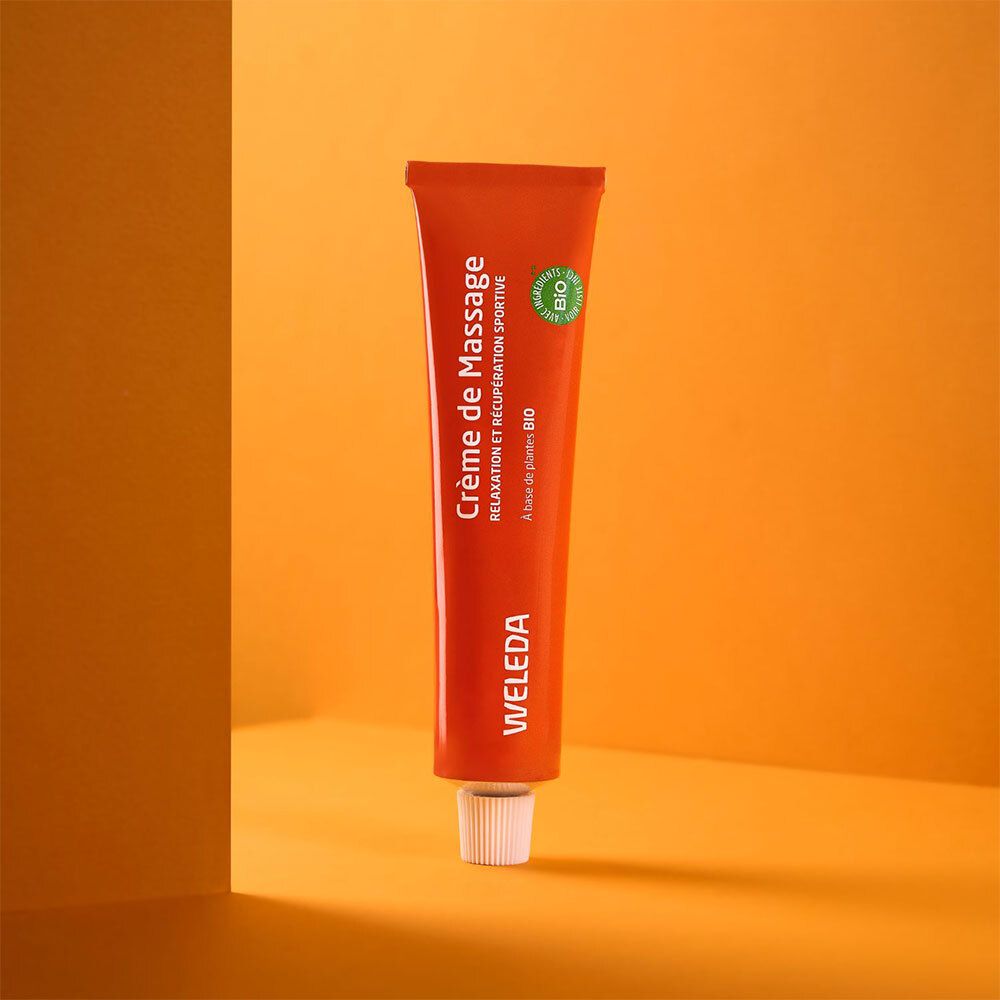 Tube orange avec bouchon blanc. Inscription: Crème de Massage, WELEDA, label BIO.