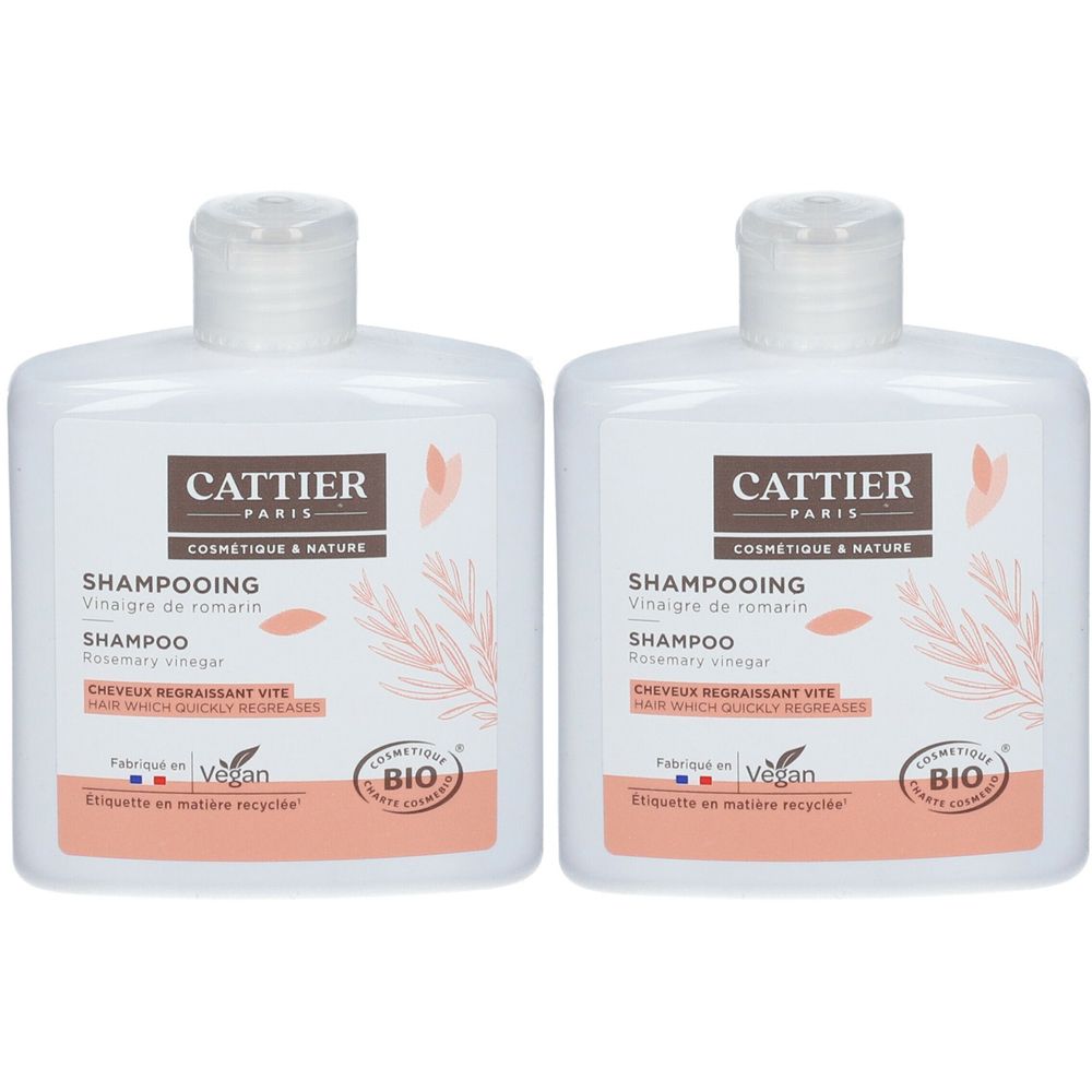 Deux flacons de shampooing blancs avec étiquettes. Inscription: CATTIER PARIS, Shampooing, Vinaigre de romarin, certification BIO, Vegan.