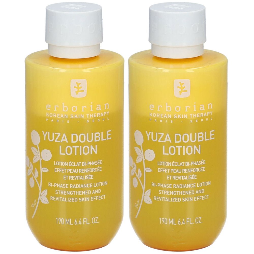 Deux flacons de lotion Yuza Double. Liquide jaune dans des flacons cylindriques avec bouchon blanc. Inscription : Erborian, Yuza Double Lotion.