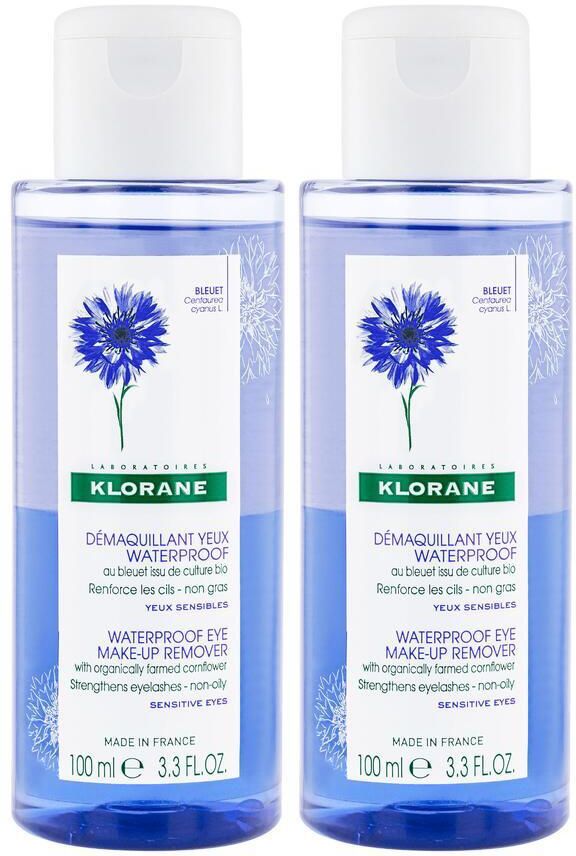 Deux flacons de Klorane Démaquillant yeux waterproof. Liquide bleu, bouchon blanc. Étiquette avec illustration de bleuet.