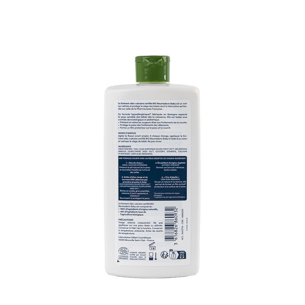 Dos d'une bouteille de liniment bébé blanc. Informations textuelles et logos. Bouchon vert.