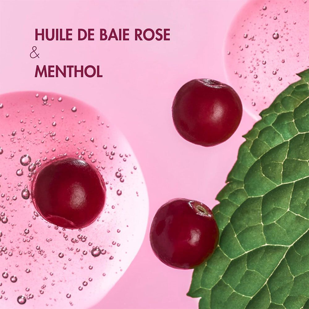 Nahaufnahme von roten Beeren, Blättern und rosa Flüssigkeit. Text: Huile de baie rose & menthol.