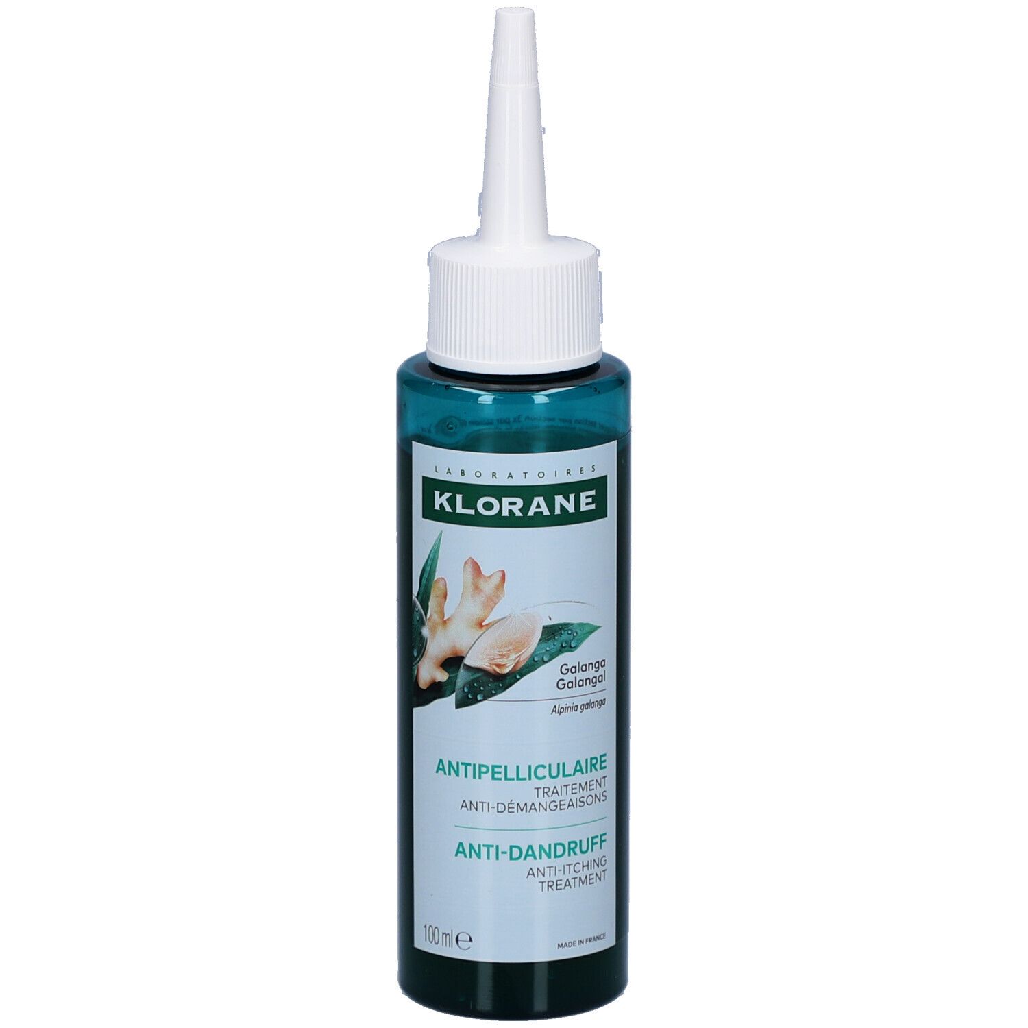 Flacon vert avec applicateur blanc. Inscriptions: KLORANE, Antipelliculaire, Anti-Démangeaisons, Anti-Dandruff Treatment. Illustration de gingembre.