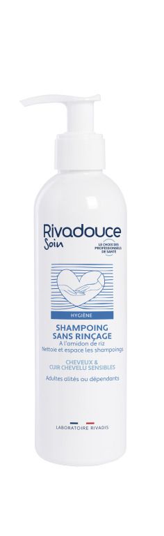 Weiße Flasche mit Spender. Aufschrift: Rivadouce Soin, Shampoo sans rinçage. Für empfindliches Haar und Kopfhaut.