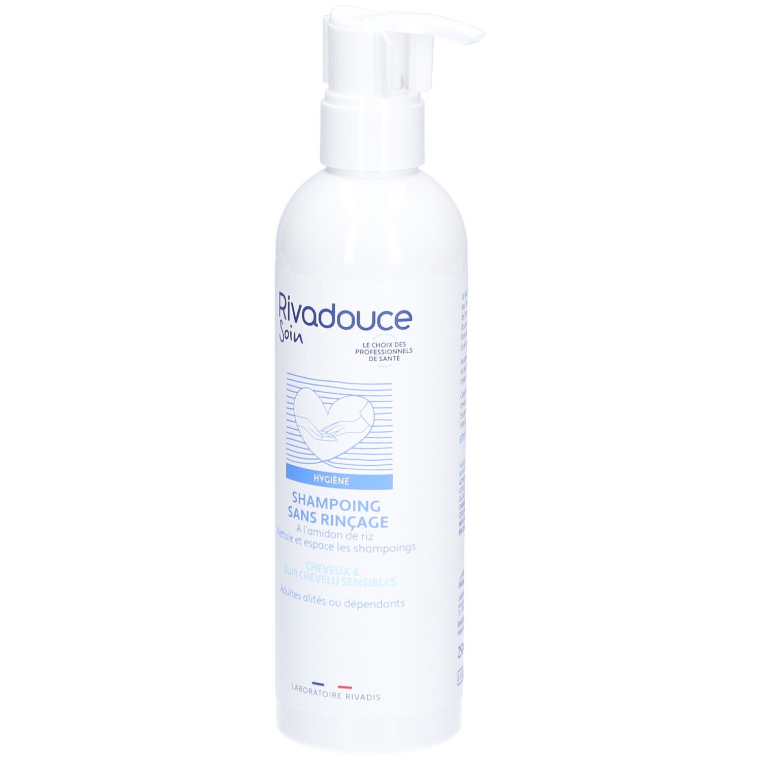 Flacon blanc avec pompe. Inscription: RIVADOUCE Soin, Shampoing Sans Rinçage. Produit d'hygiène pour adultes et personnes dépendantes.