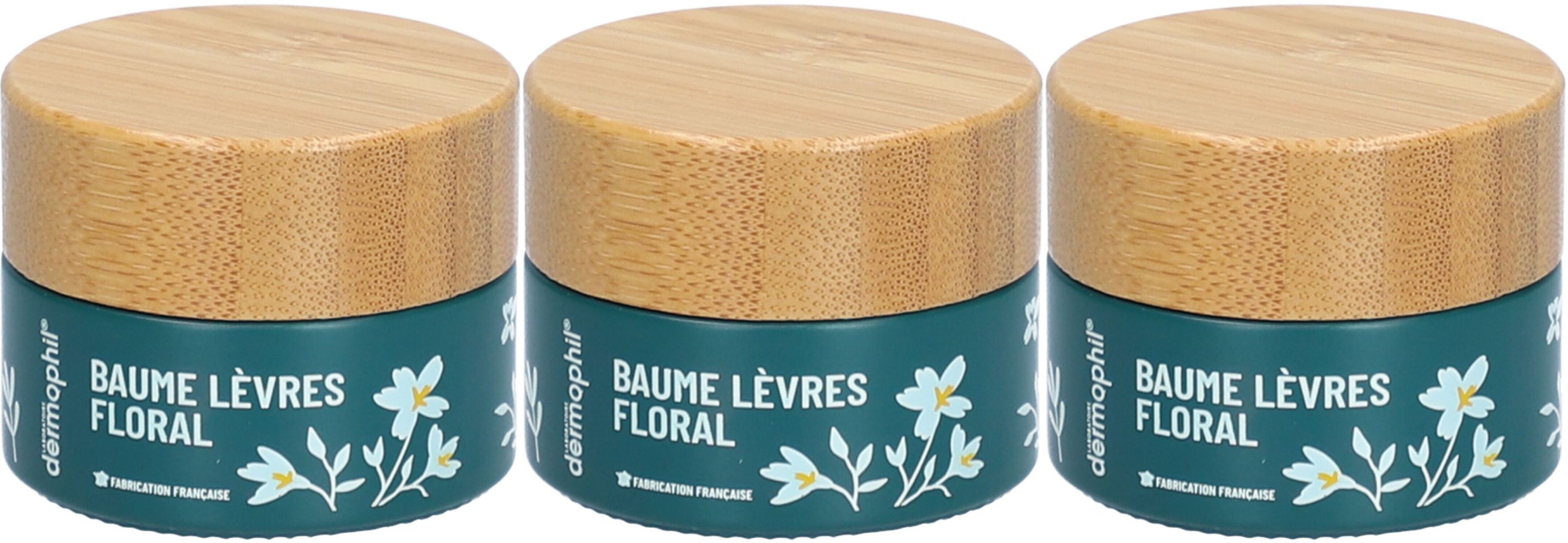 Drei Tiegel Lippenbalsam mit Holzdeckel. Aufschrift: BAUME LÈVRES FLORAL. Türkisgrüner Behälter mit weißen Blumen. Marke: Dermophil.