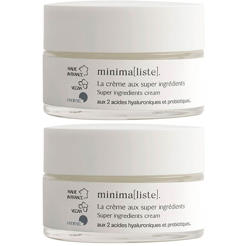 Deux pots de crème avec couvercles blancs et pots en verre. Inscription : minima[liste]. La crème aux super ingrédients. Certification Vegan.
