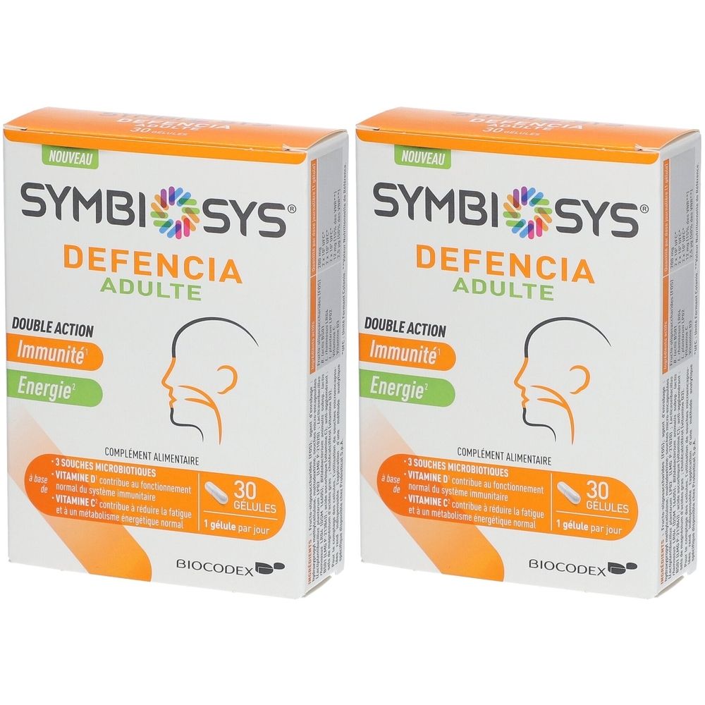 Deux boîtes SYMBIOSYS Defencia Adulte. Boîtes blanches avec accents orange et verts. Inscription : Double Action, Immunité, Energie.