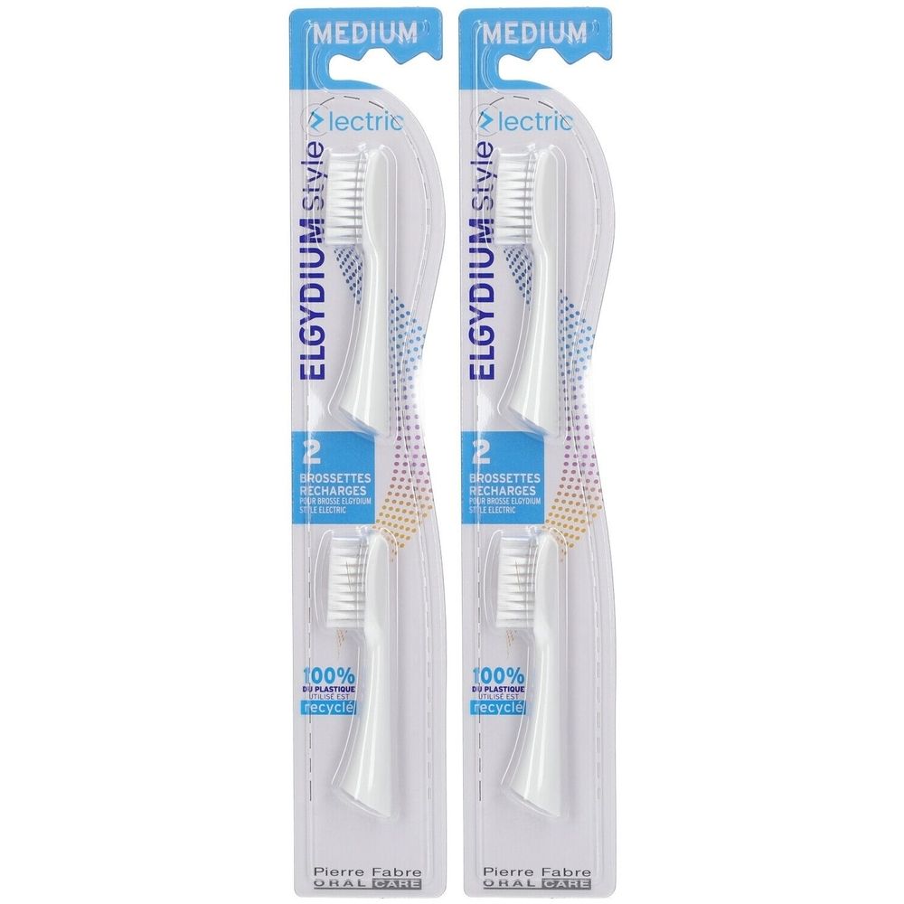 Zwei weiße elektrische Zahnbürstenaufsätze in Verpackung. Aufschrift: ELGYDIUM Style, 2 Bürsten, Medium. 100% recyceltes Plastik.