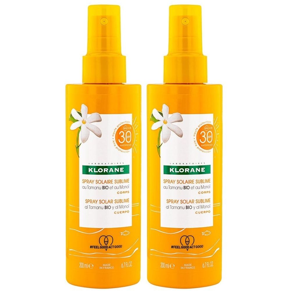 Zwei gelbe Sprays mit Sprühkopf. Aufschrift: KLORANE, Spray Solaire Sublime. Mit SPF30-Logo und Blumen-Illustration.