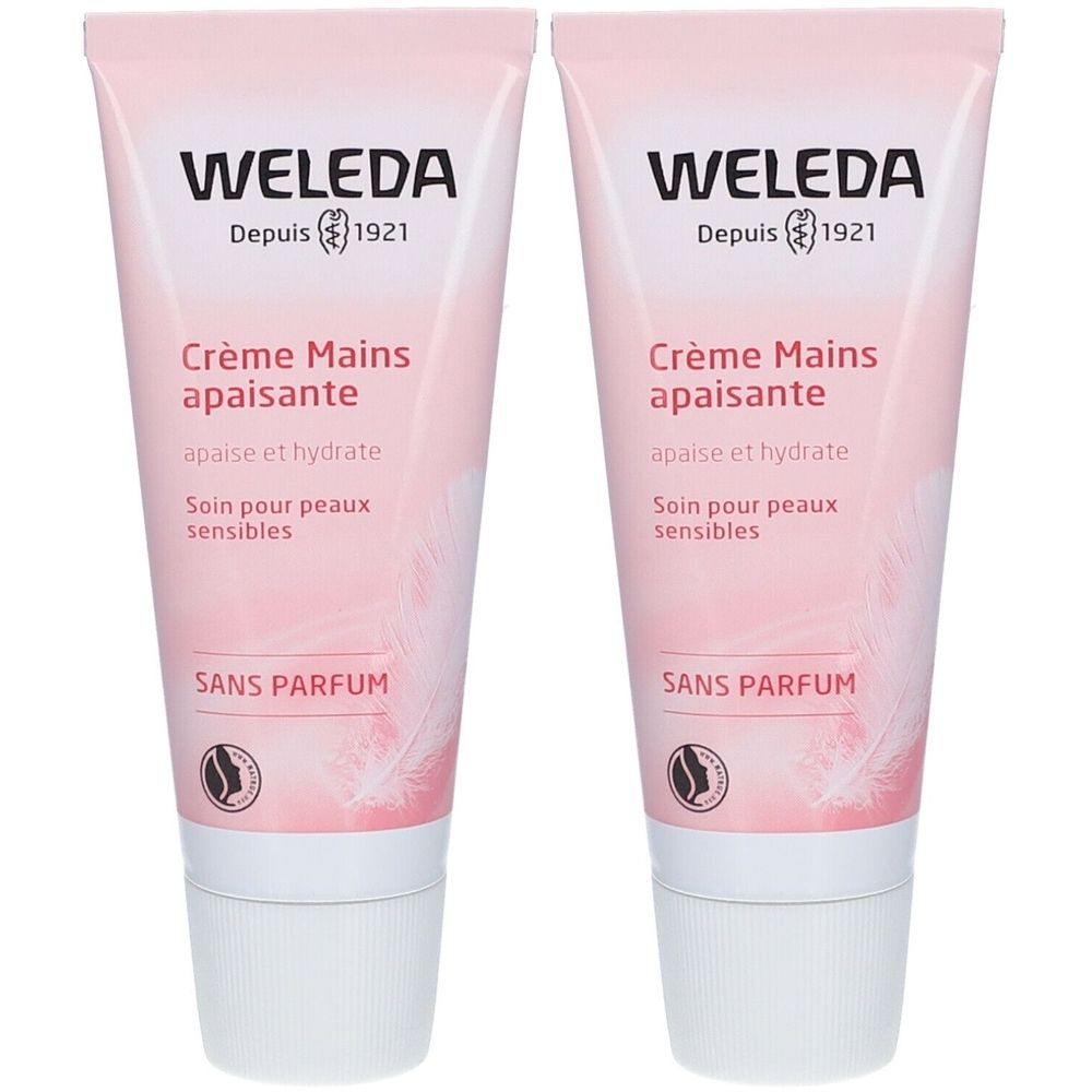 Zwei Tuben Handcreme. Rosa-weißes Design. Aufschrift: WELEDA, Crème Mains apaisante, SANS PARFUM.