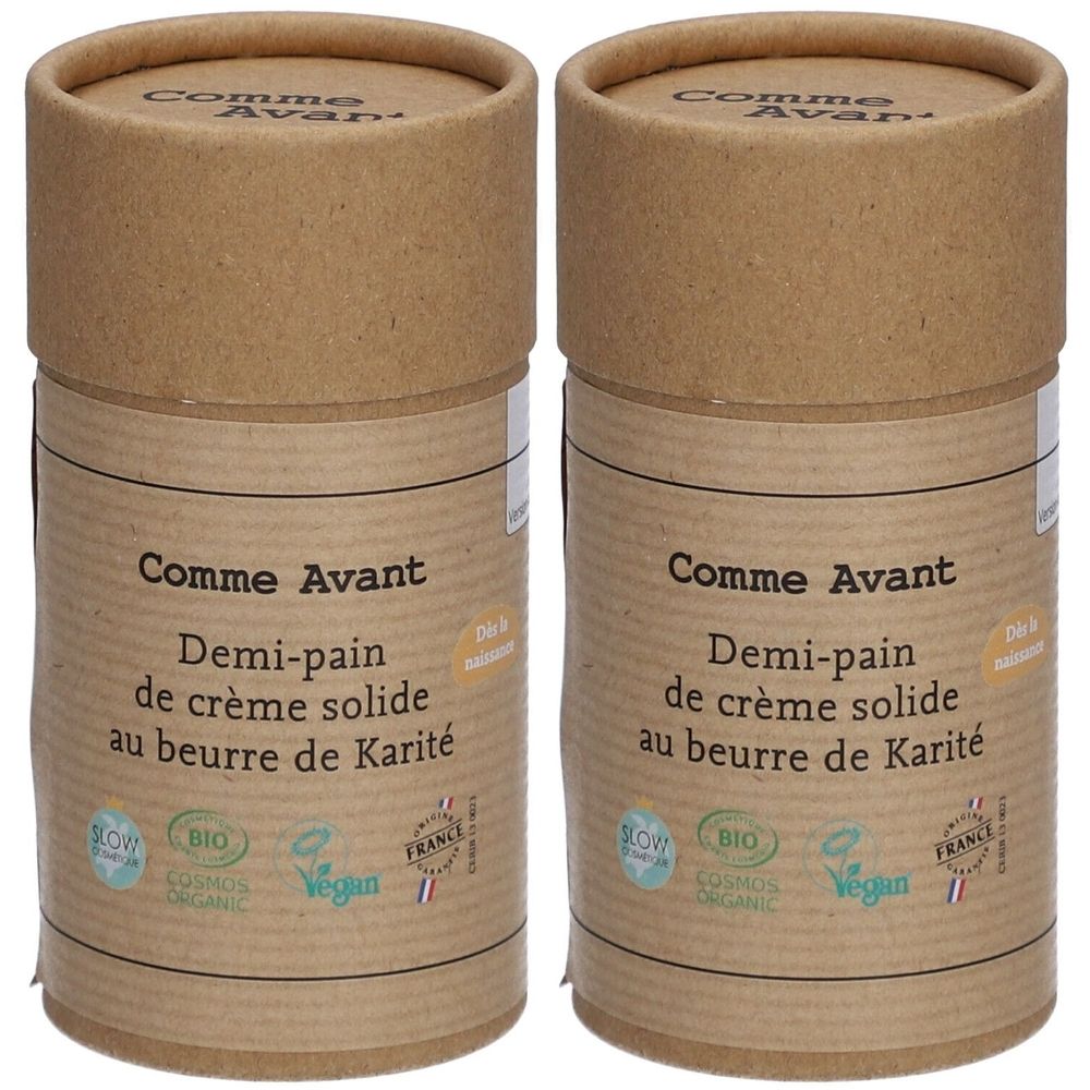 Deux contenants cylindriques en carton brun. Inscription: Comme Avant, Demi-pain de crème solide au beurre de Karité. Logos bio et vegan.