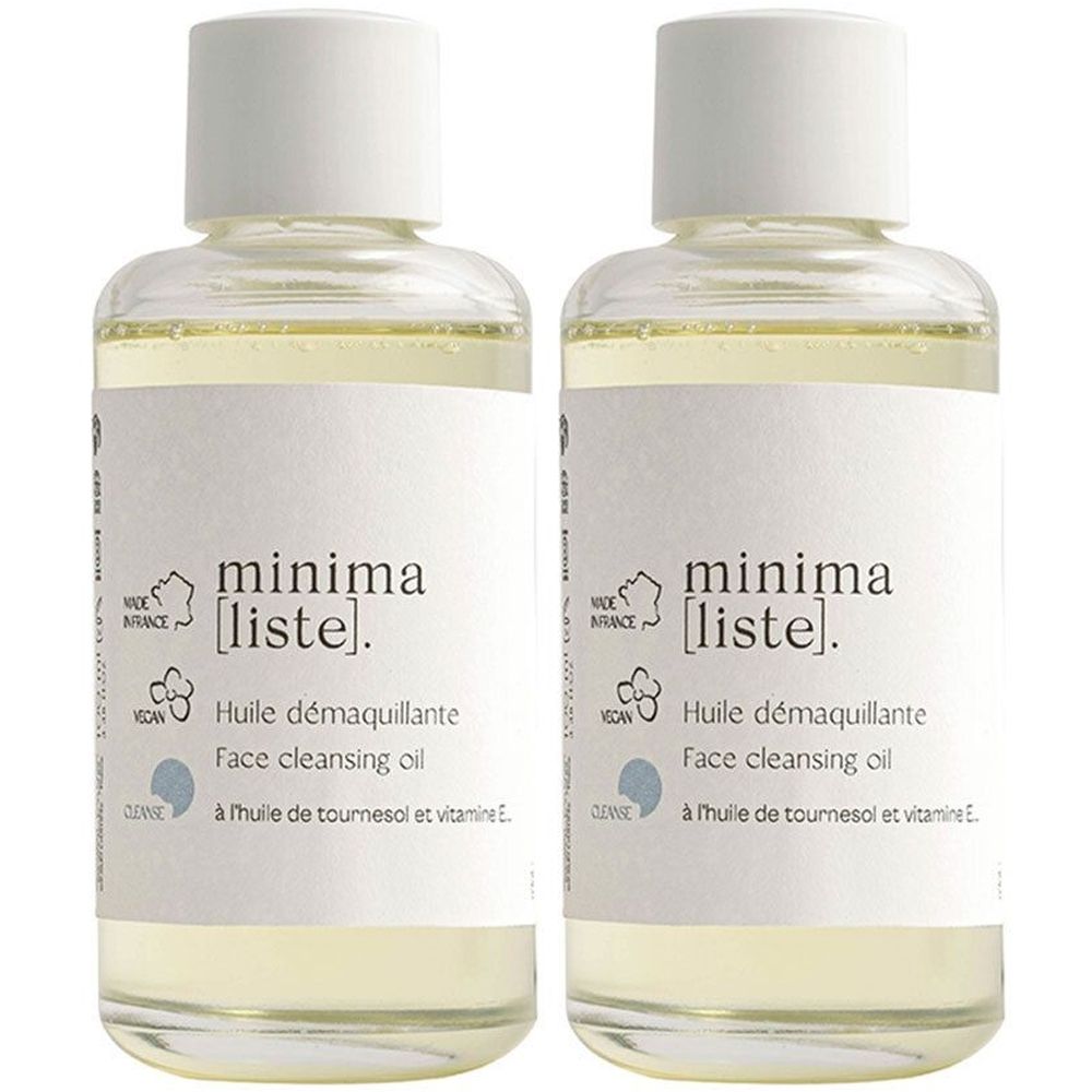 Deux flacons d'huile démaquillante minima [liste]. Liquide clair dans des flacons en verre avec des bouchons blancs. Inscription : Huile démaquillante.