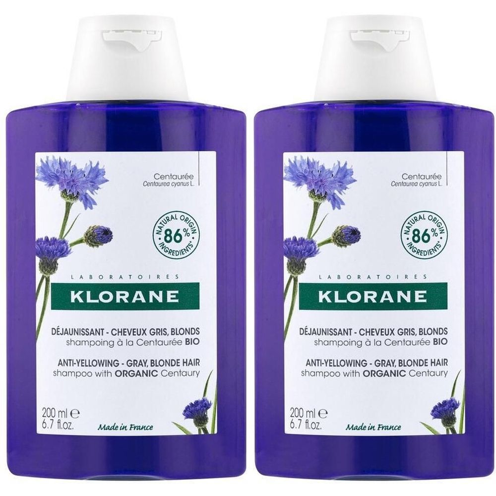 Zwei violette Flaschen mit weißem Deckel. Aufschrift: KLORANE, Anti-Gelbstich-Shampoo für graues und blondes Haar mit Bio-Kornblume.