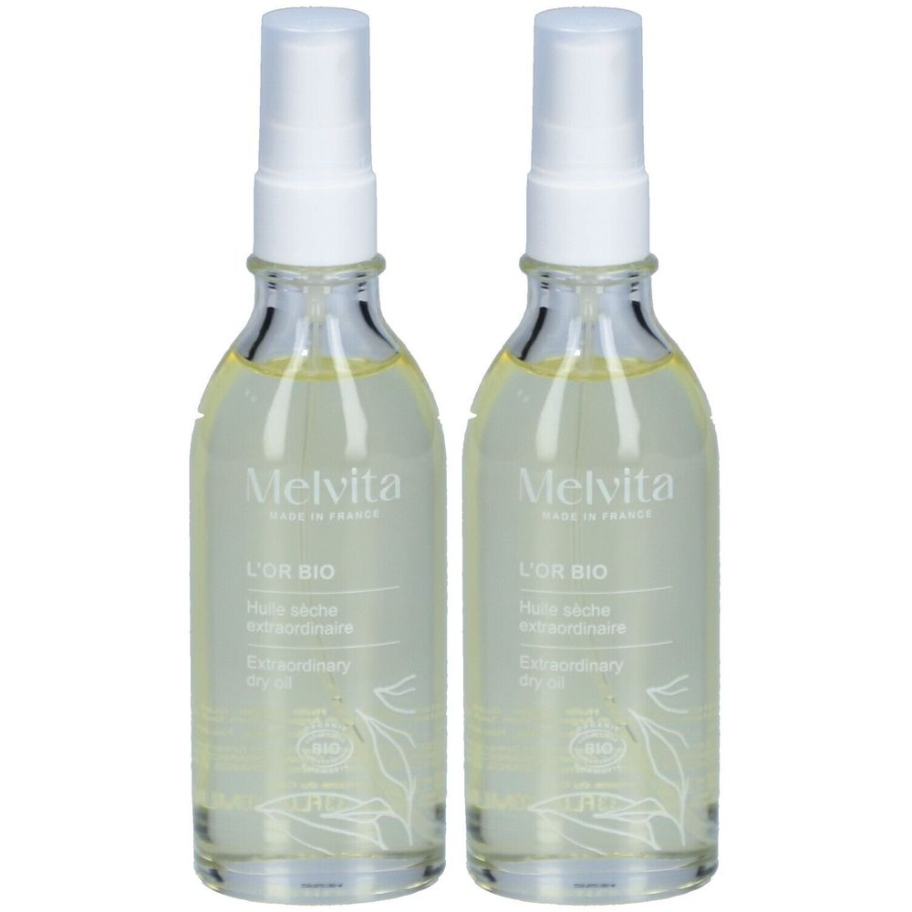 Deux flacons en verre avec vaporisateur. Inscription: Melvita, L'Or Bio, Huile sèche extraordinaire, Extraordinary dry oil. Label bio.