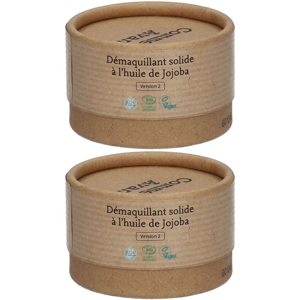 Zwei zylindrische Behälter aus braunem Karton. Auf der Seite steht "Démaquillant solide à l'huile de Jojoba". Oben steht "Comme Avant".